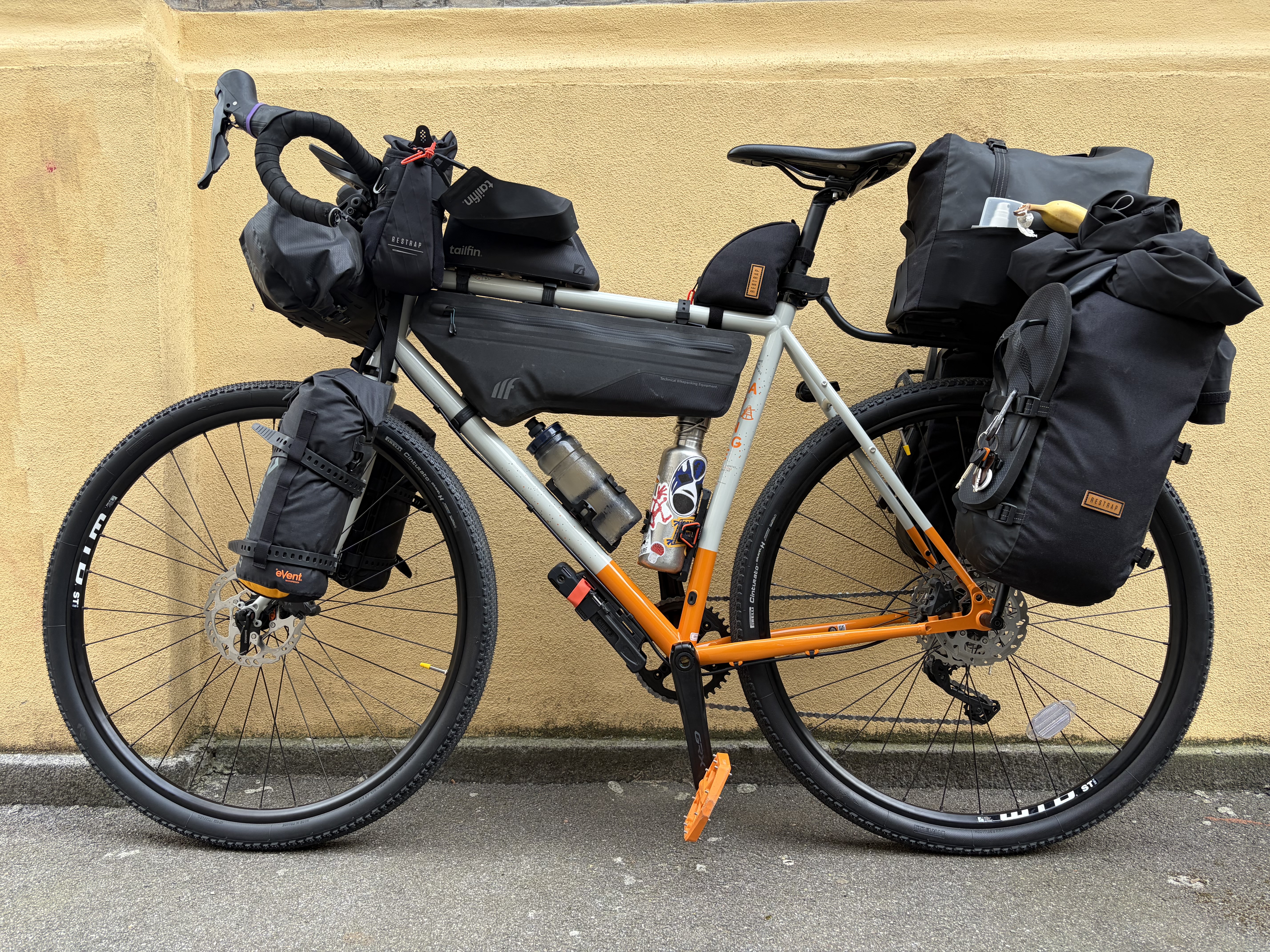 Angelica, the loaded expedition bicycle, against a warm yellow wall